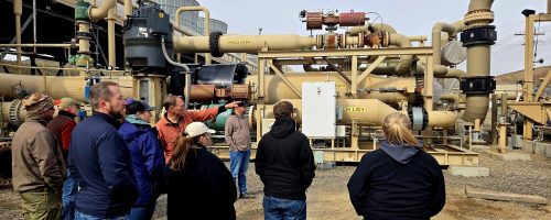 a group of people standing outside at a geothermal facility, March 14, 2025