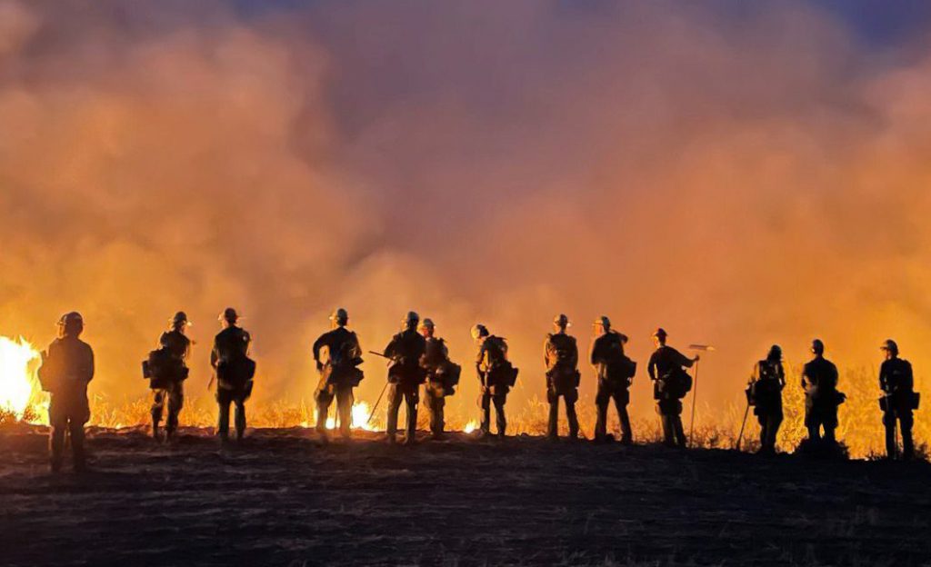 Firefighting crew looking at a fire